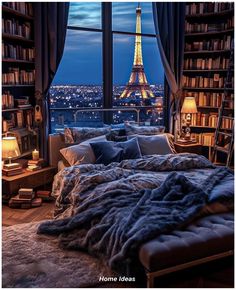 a bedroom with a view of the eiffel tower in paris, france at night