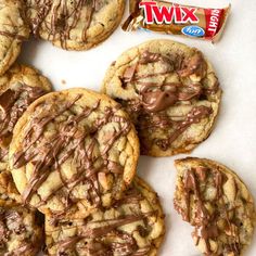 cookies with chocolate drizzled on them and a bar of twix