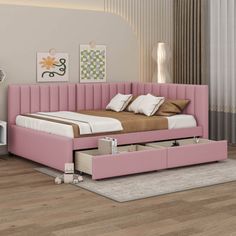 a pink bed with two drawers underneath it