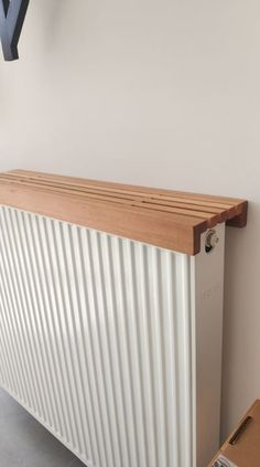 a white radiator sitting next to a brown box