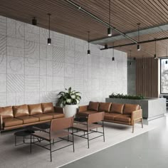 a living room with couches and chairs in front of a large wall mounted planter