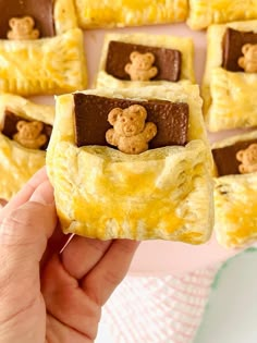 someone is holding up some desserts with teddy bears on them in the shape of squares