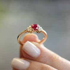 The Julie Ring is a colorful band inlaid with a ruby gemstone center, surrounded by round brilliant diamonds. **Due to the nature of the natural Ruby the color may vary** All features can be customized! please contact us if you wish to make changes, we love making custom designs. All of our jewelry is carefully handmade in our atelier *HC diamond are all conflict free diamonds To order by phone click here>> +972(0)722991000 Round Ruby Ring Design, Promise Ruby Diamond Ring With Prong Setting, Ruby And Gold Ring, Ruby Diamond Ring With Accent Stones And Round Cut, Ruby Ring With Halo Setting For Promise, Promise Ruby Ring With Halo Setting, Ruby Rings With Halo Setting For Promise, Ruby Ring With Diamond Accent Stones, Red Ruby Ring With Brilliant Cut For Proposal