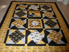 a yellow and black quilt on the floor