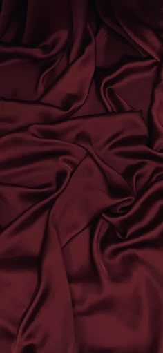 an image of a bed with red sheets