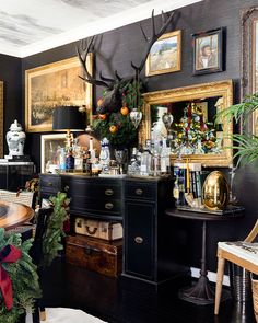 a dining room with antlers on the wall and pictures on the wall above it