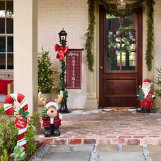 christmas decorations are on the front porch of a house