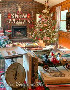 a living room filled with furniture and a christmas tree in front of a fire place