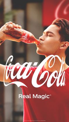 a man drinking coca - cola from a bottle with the words real magic written on it