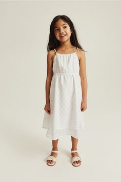 Calf-length dress in airy chiffon with a narrow cut at top. Narrow  rope shoulder straps  elasticized trim at upper edge  and elastic at waist. Asymmetric hem. Lined. Rainbow Dress Girl, Pattern Dresses, Girls Winter Dresses, Girls Cotton Dresses, Summer Family Photos, Rope Pattern, Girl Red Dress, Calf Length Dress, Seersucker Dress