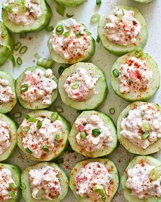 cucumbers stuffed with crab salad on a white platter, ready to be served