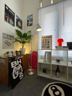 a room with various items on the floor, including a desk and chair in front of a window