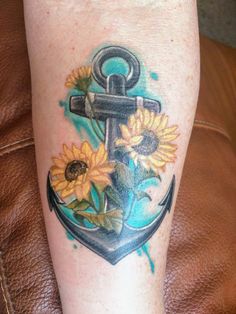 an anchor and sunflowers tattoo on the leg