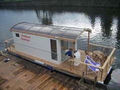 a small houseboat is docked on the water