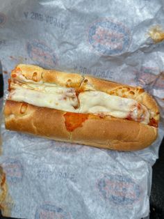 a hot dog covered in cheese and sauce