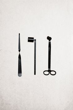 an assortment of scissors and other tools on a white surface