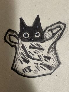 a drawing of a cat sitting in a vase with eyes drawn on it's side