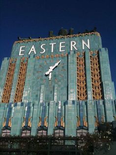 a large building with a clock on it's side and the words eastern above it