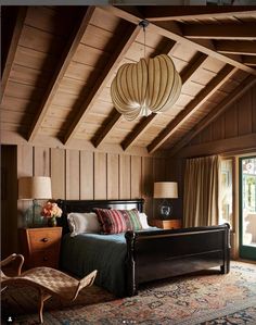 a bedroom with wood paneling and wooden ceiling