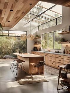 an open kitchen with lots of counter space and wooden accents, along with hanging lights