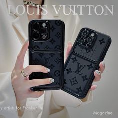 a woman holding two black cases with louis vuitton designs on them, both in front of her