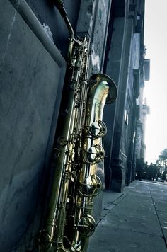 a saxophone leaning against the side of a building