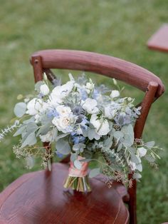 a bouquet of flowers sitting on top of a wooden chair