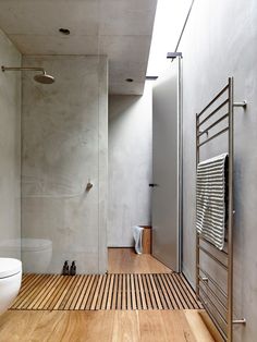 a bathroom with wooden flooring and white walls