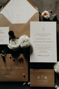 the wedding stationery is laid out on top of each other