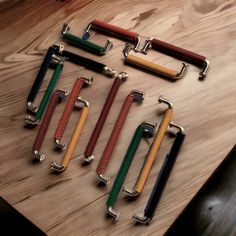 six different colored handles on a wooden table