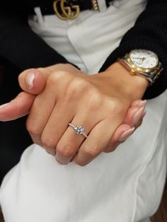 a close up of a person wearing a ring on their finger