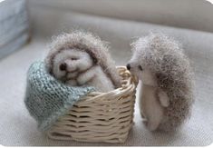 two small stuffed hedges in a basket