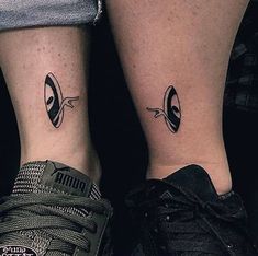 two people with matching tattoos on their legs, one has an eye and the other has a