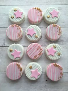 pink and white decorated cookies with stars on them