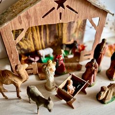 a nativity scene with figurines in the foreground and an open manger