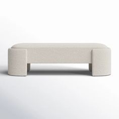 a white bench sitting on top of a white floor