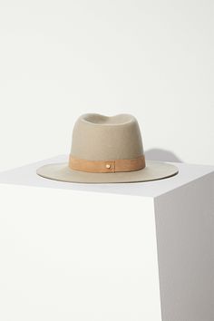 Design Our classic packable hat shape in clay wool with a tonal beige suede band. The flattering and neutral color for all shades of skin and hair. This hat is made from packable wool which means you can easily pack it away in your luggage or bag wherever you may go. This is a staple hat to any wardrobe. Material Our packable wool is sustainable and cruelty-free. We clean, scour and dye our wool in our employee-owned factory right here in the United States. From shearing the wool, to hand polish Elegant Solid Fedora For Everyday Wear, Classic Felt Hat For Fall, Classic Felt Hat For Everyday Fall Wear, Classic Wide Brim Felt Hat For Everyday, Classic Brimmed Felt Hat For Everyday, Everyday Solid Felt Hat With Short Brim, Everyday Felt Hat With Short Brim, Everyday Leather Fedora With Flat Brim, Classic Fitted Felt Hat For Everyday