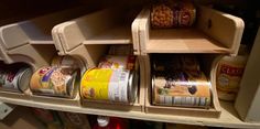 an organized pantry with canned food items in the bottom shelf and on the top shelf