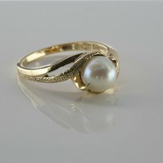 Vintage 10K Yellow Gold Pearl Ring, pierced top shank, bypass design, 6mm pearl center, green highlights, florentine finish to half of the split shanks, pierced sides, Ring size 6.75, Circa 1960, 3.2 grams SKU # BB272R05 Most rings are sizable for a small fee. If the ring you are considering is the incorrect size contact us for a quote. This listing contains photographs of the actual item you will receive. Our items are in excellent condition with little or no signs of wear and many are one of a Pearl Ring Designs Gold, Heirloom Pear-shaped Jewelry For Formal Occasions, Pearl Rings In Gold, Pearl Ring Design, Gold Coin Ring, Pearl Rings Vintage, Cultured Pearl Ring, Pearl Rings, Cute Engagement Rings