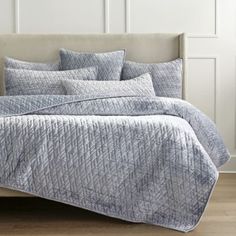 an image of a bed with pillows and blankets