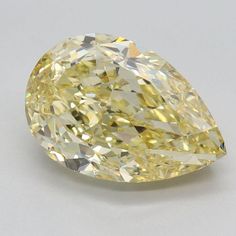 a yellow diamond on a white surface