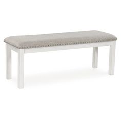 a white bench with a light colored upholstered seat