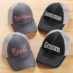 three bride and groom truckers hats sitting on top of a wooden floor with the word bride written in different colors