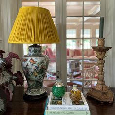 a lamp and some books on a table