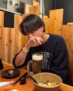 a person sitting at a table with food and drinks