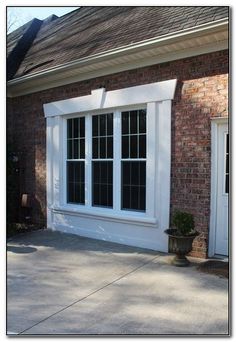 a brick house with white doors and windows