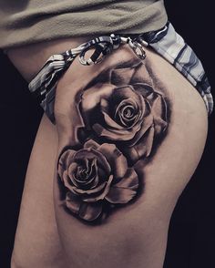 a woman's thigh with two roses on it