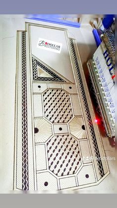 an open book sitting on top of a table next to some pens and paper cutters