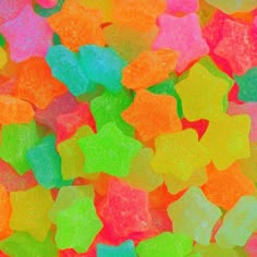 many different colored gummy bears are scattered together