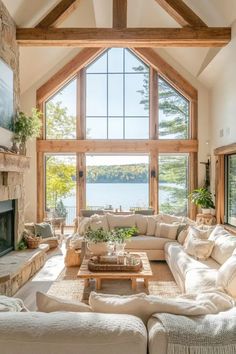 a living room filled with lots of furniture and a fire place in front of a large window